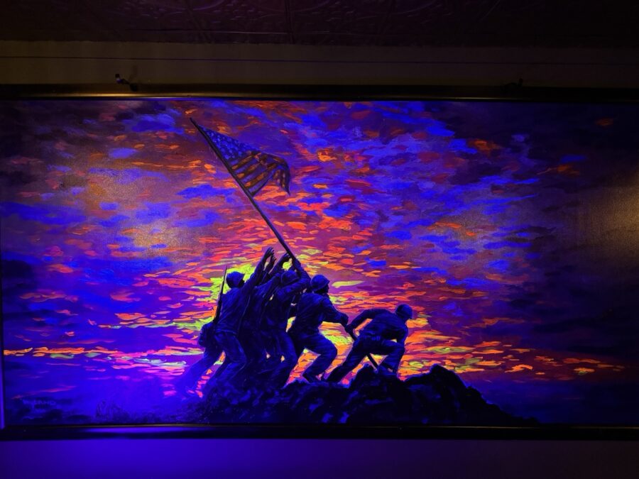 a painting of a group of soldiers raising the flag