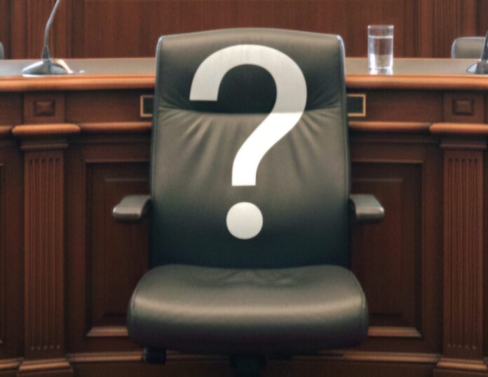 a chair sitting in front of a desk with a question mark on it