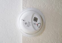 a white smoke detector mounted on a wall