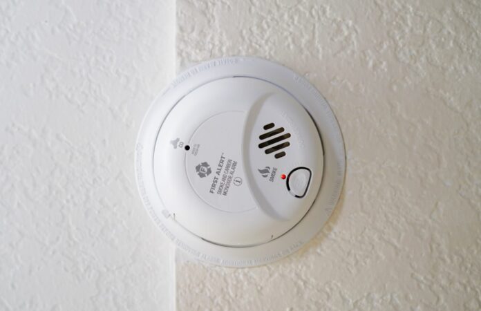 a white smoke detector mounted on a wall