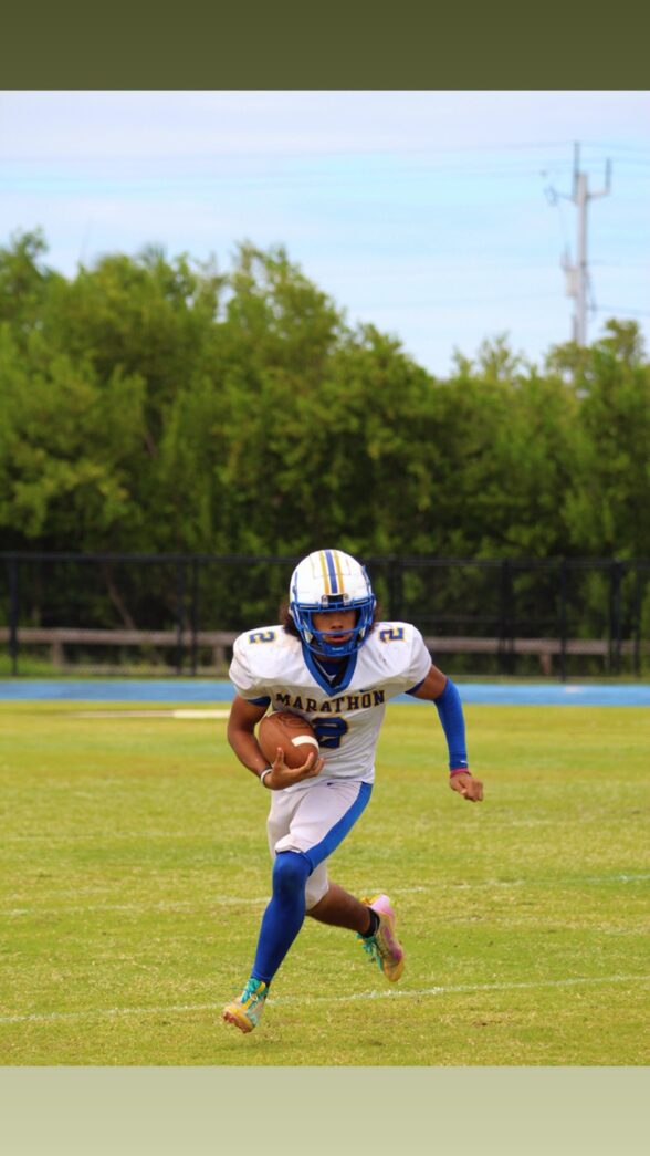 a football player running with the ball in his hand