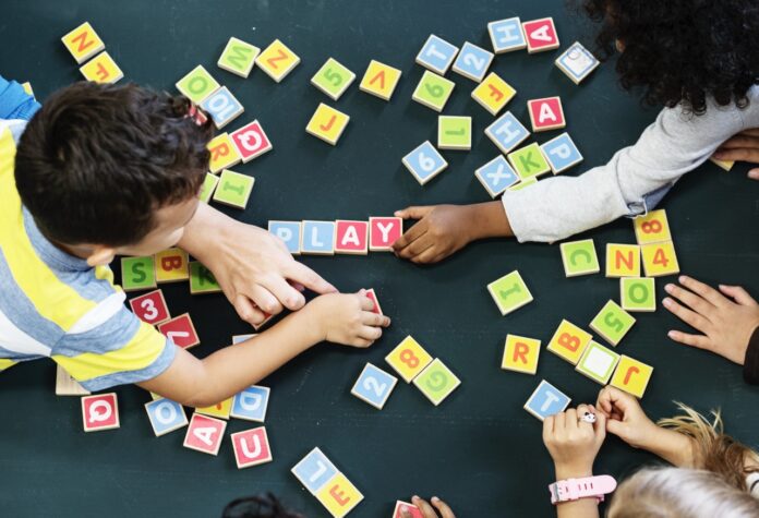 a group of children playing with letters and numbers