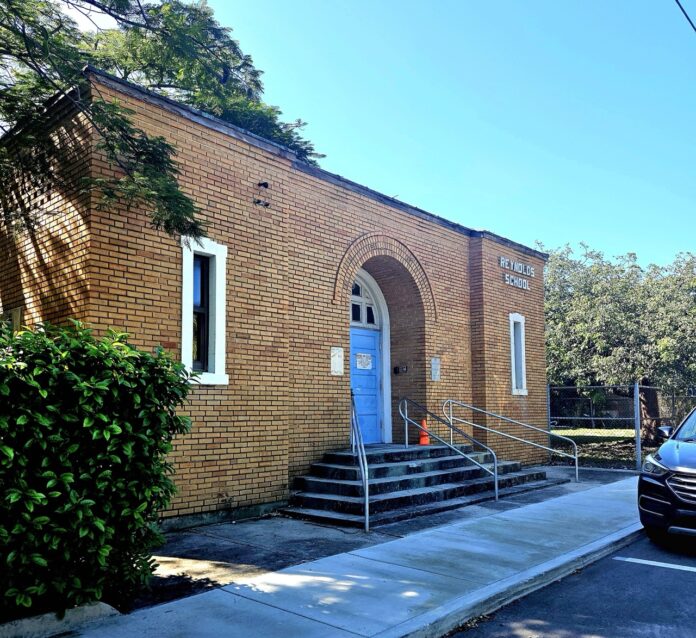 a car parked in front of a brick building