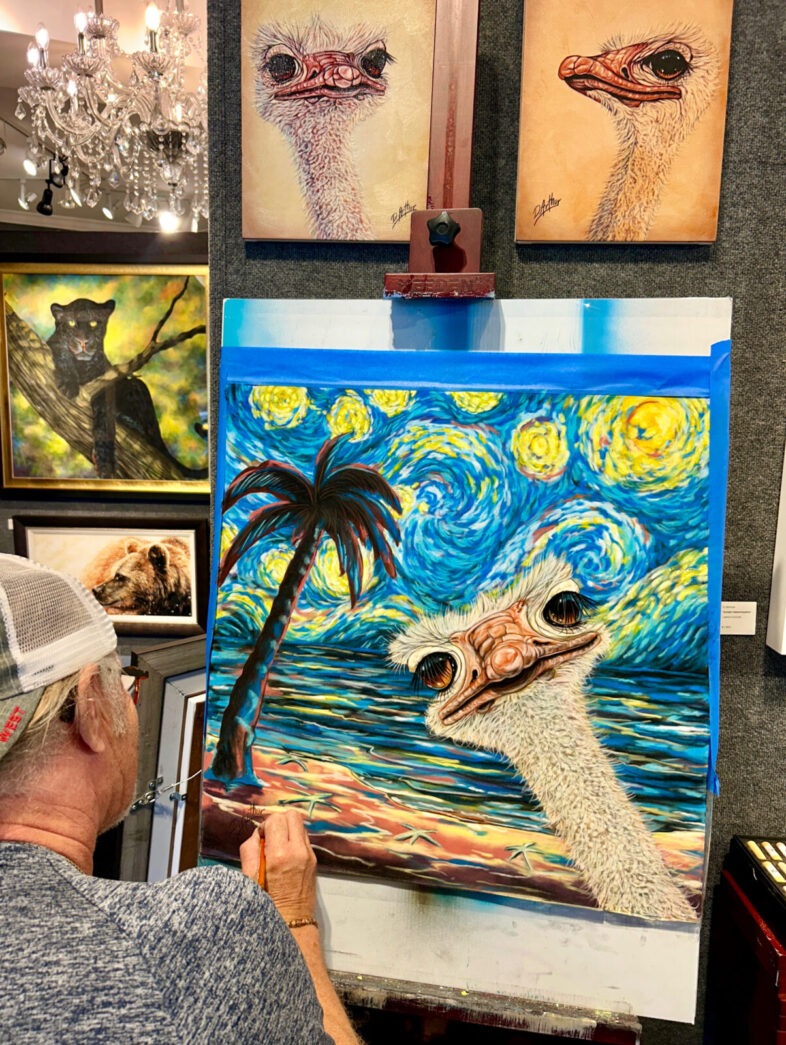 a man is painting a picture of an ostrich