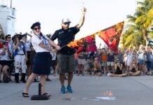 a man standing next to a woman on top of a street