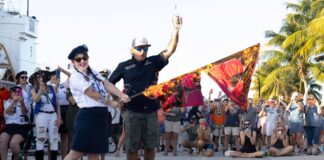 a man standing next to a woman on top of a street