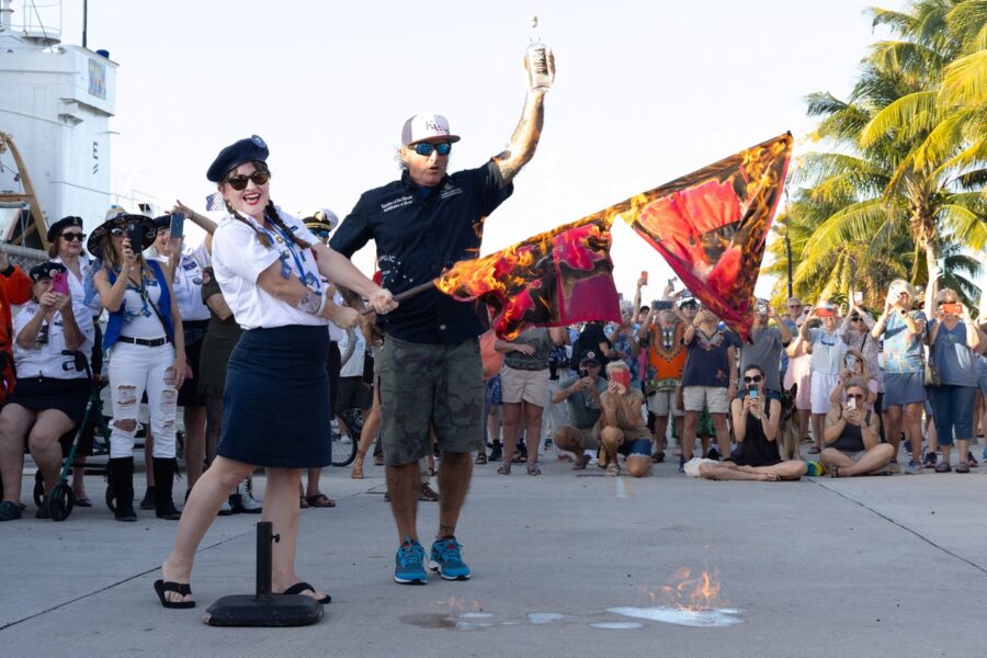 a man standing next to a woman on top of a street
