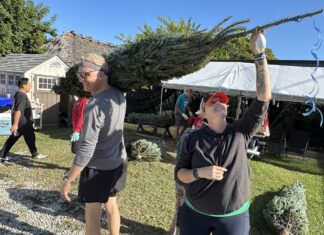 a group of people standing on top of a grass covered field