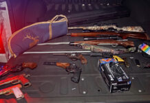 OUT-OF-COUNTY MEN ARRESTED FOR ALLEGEDLY STEALING KEY LARGO STORAGE TRAILER WITH GUNS the back of a car with a bunch of guns in the trunk