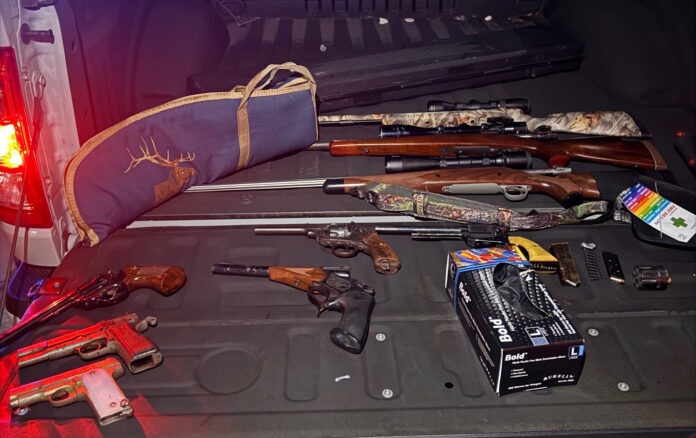 120525 Storage trailer theft the back of a car with a bunch of guns in the trunk