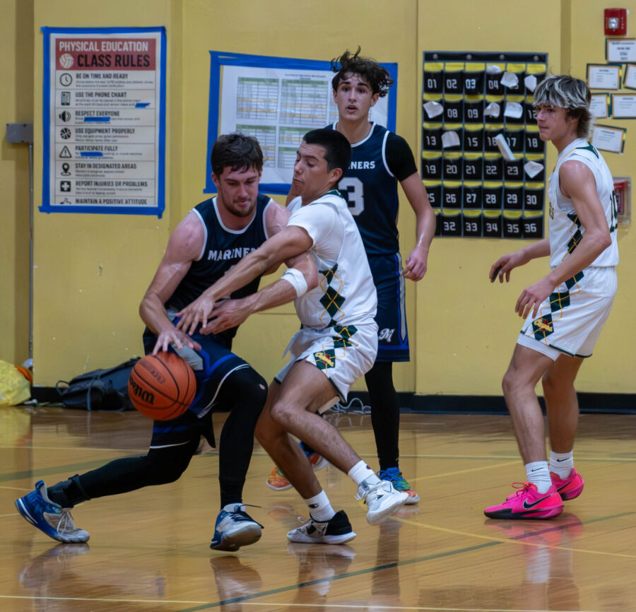 a group of young men playing a game of basketball