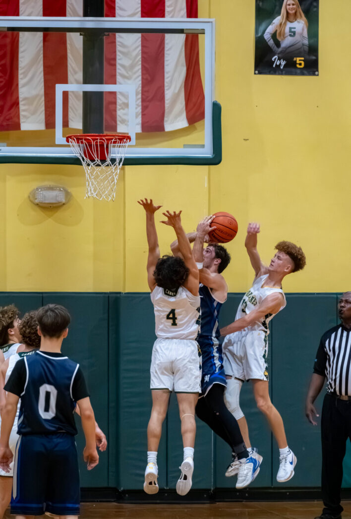 a group of young men playing a game of basketball