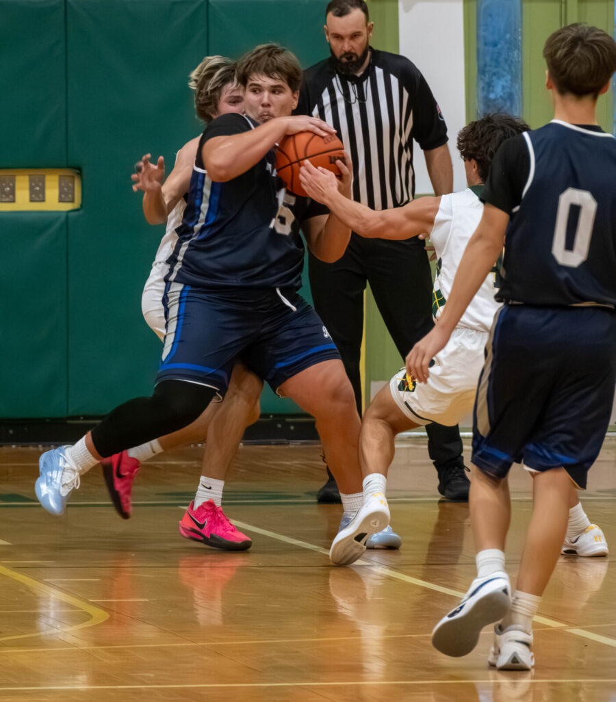 a group of young men playing a game of basketball
