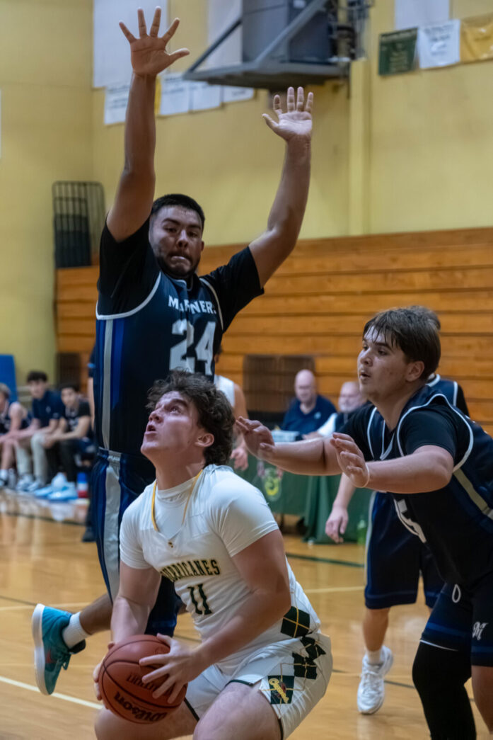 a group of young men playing a game of basketball