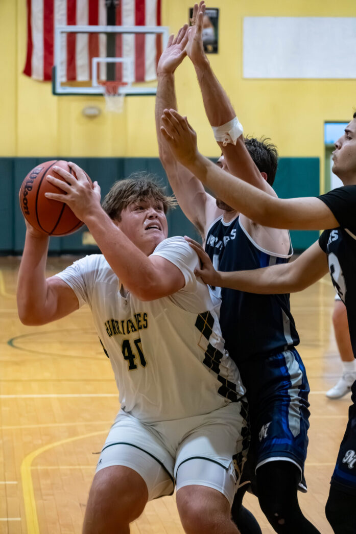 a group of young men playing a game of basketball