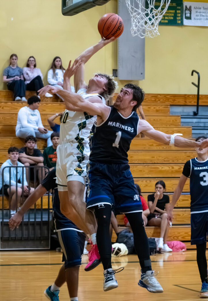 a group of young men playing a game of basketball