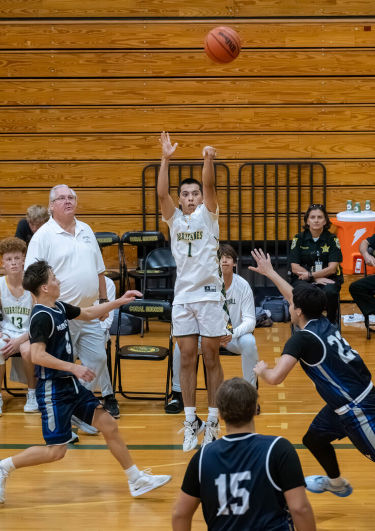 a group of young men playing a game of basketball
