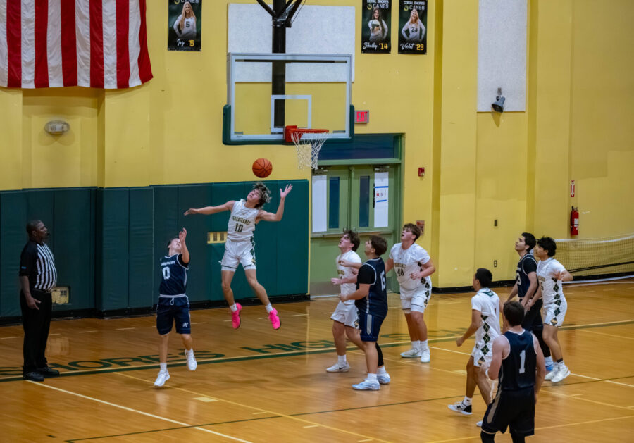 a group of young men playing a game of basketball