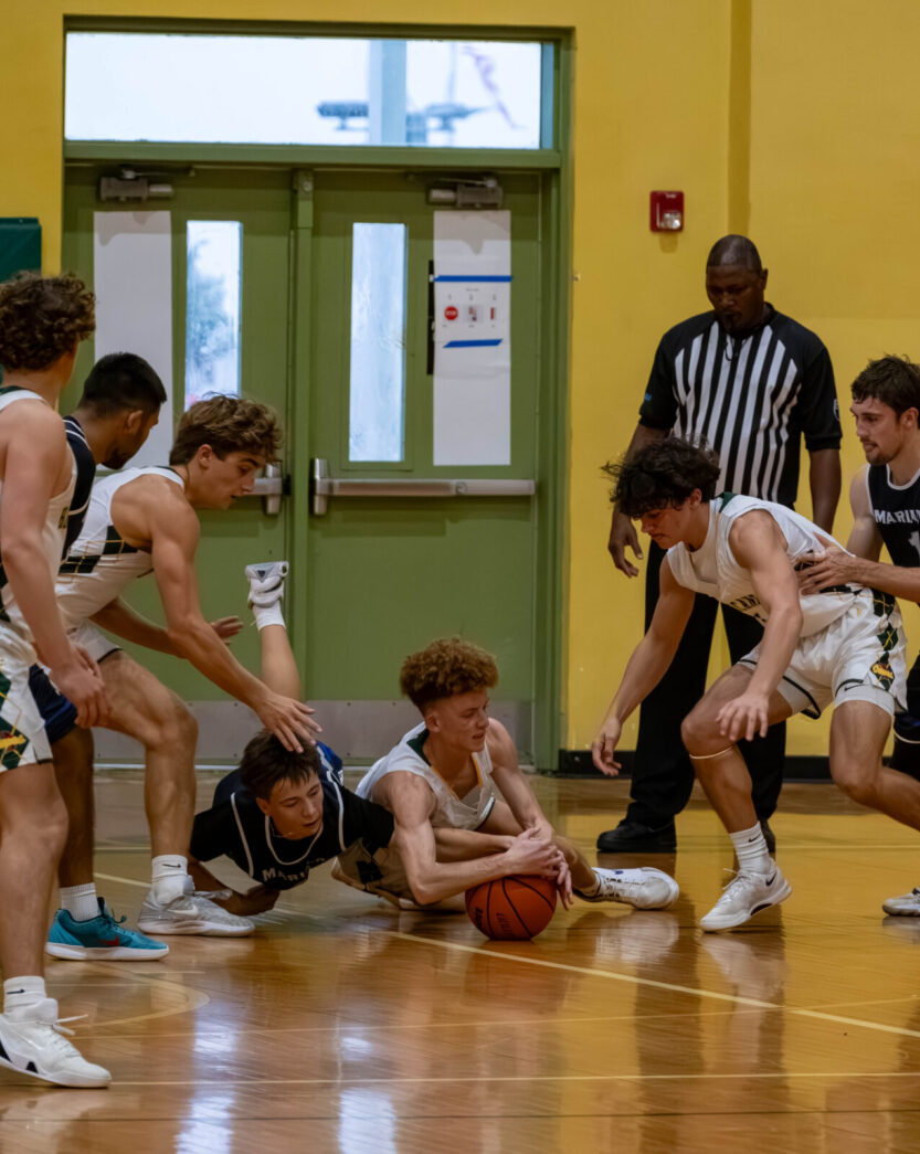 a group of young men playing a game of basketball