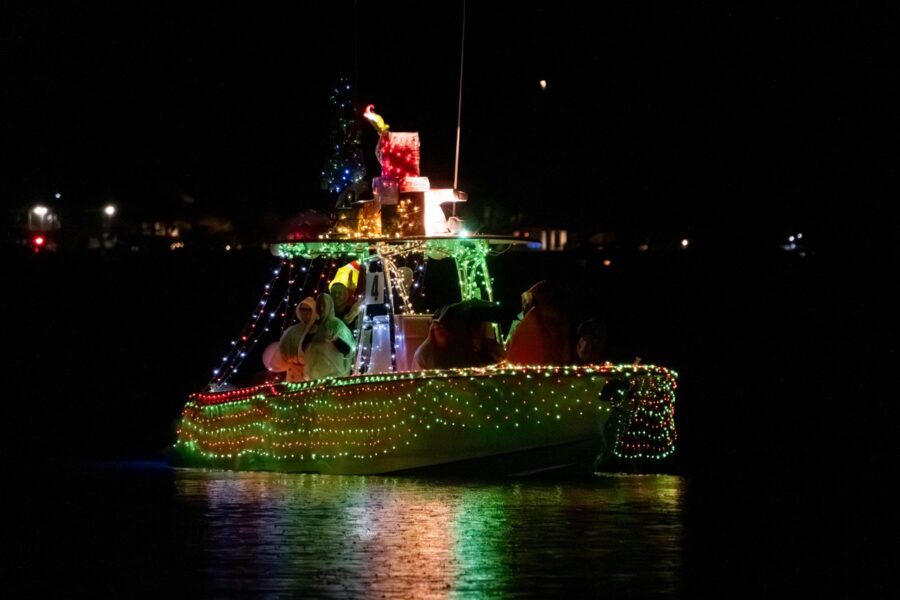 a boat decorated with christmas lights on the water