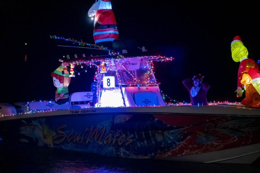 a boat decorated with christmas lights on the water
