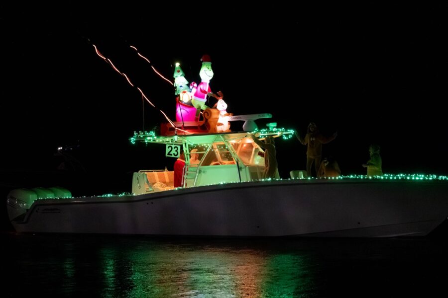 a boat decorated with christmas lights on the water