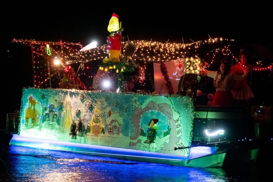 a boat decorated with christmas lights on the water