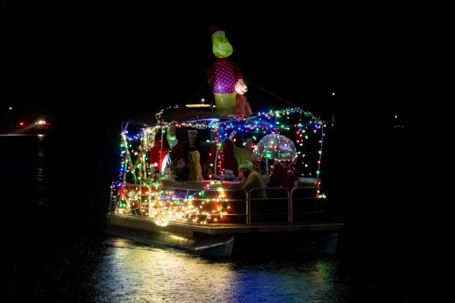 a boat decorated with christmas lights on the water