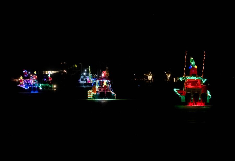 a group of boats with christmas lights on them