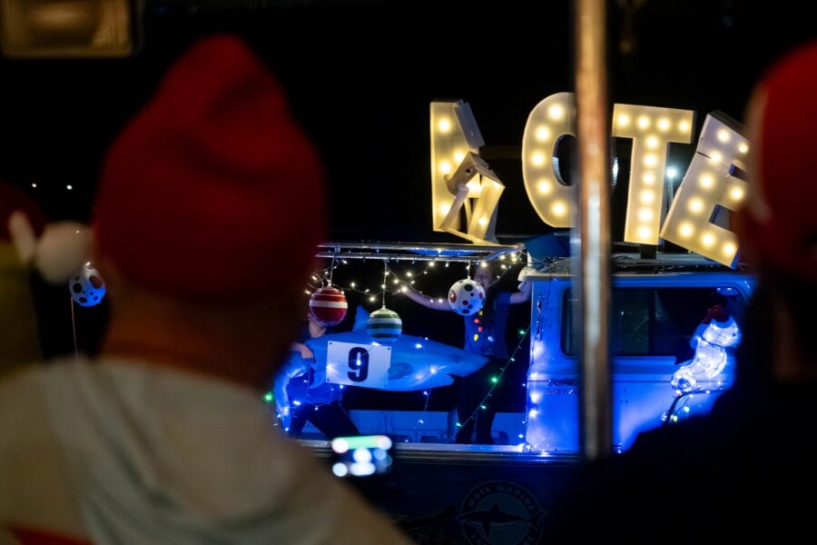 a couple of people that are standing in front of a sign