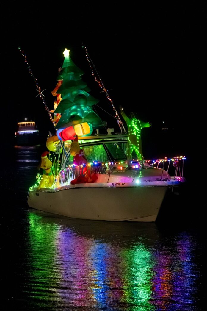 a boat with a christmas tree on it in the water