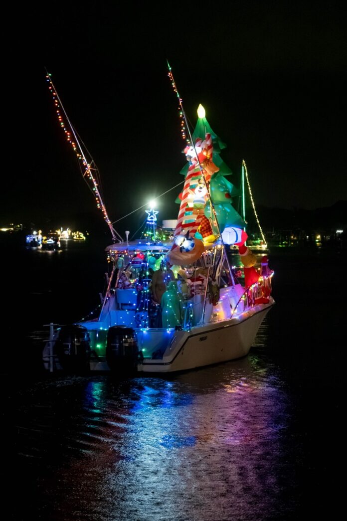 a boat with a christmas tree on it in the water