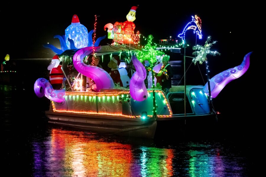 a boat decorated with christmas lights on the water