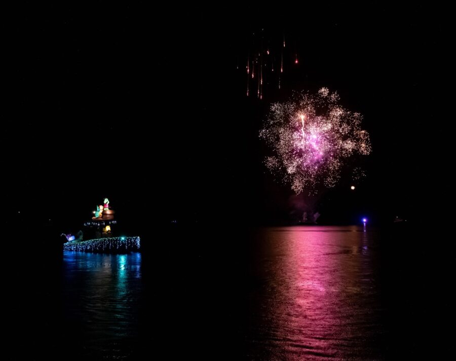 a boat floating on top of a body of water at night