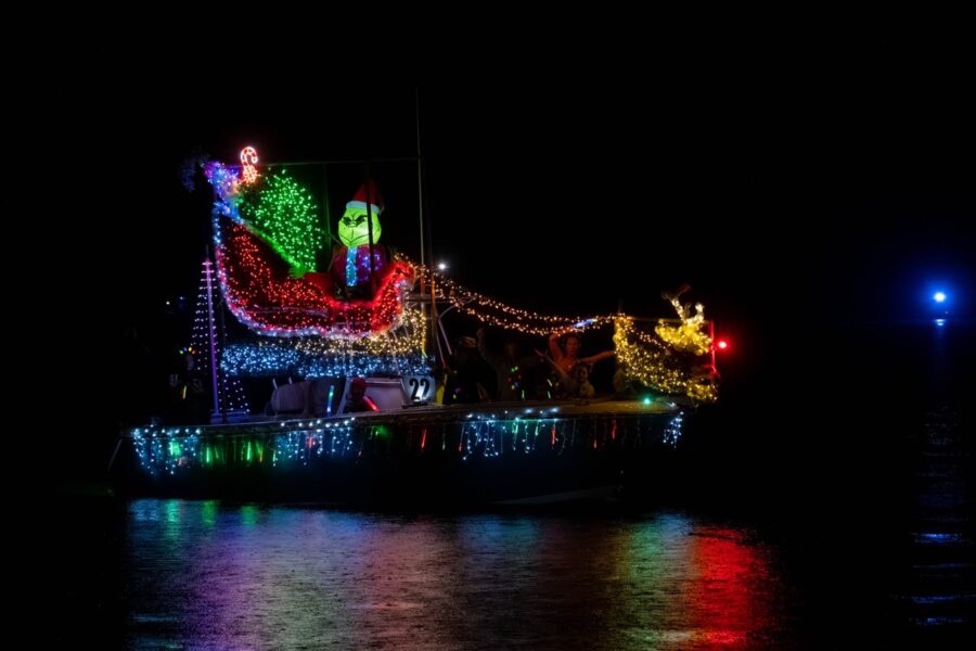 a boat decorated with christmas lights on the water