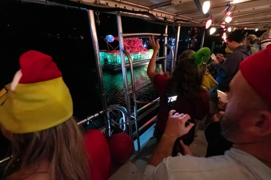 a group of people riding on a boat at night