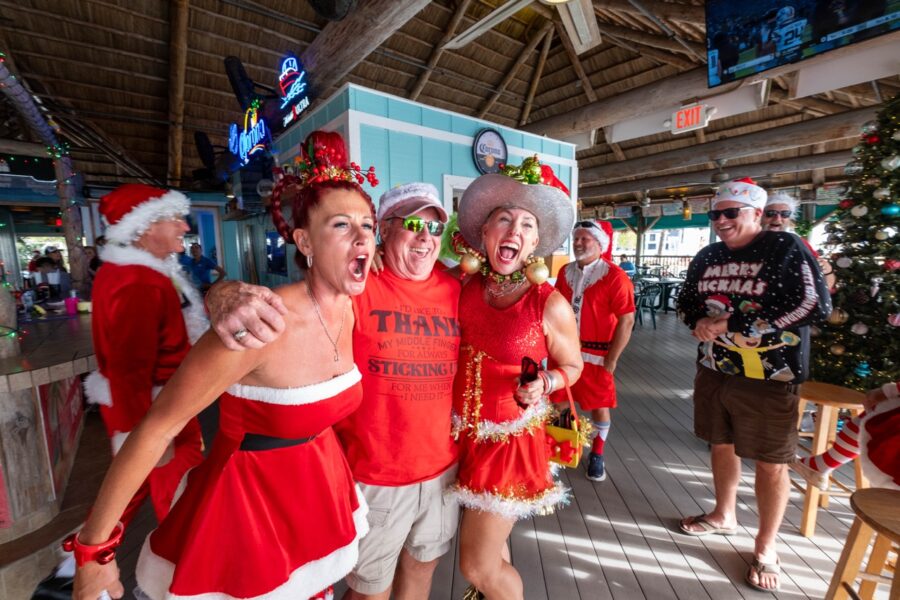a group of people dressed up in santa costumes