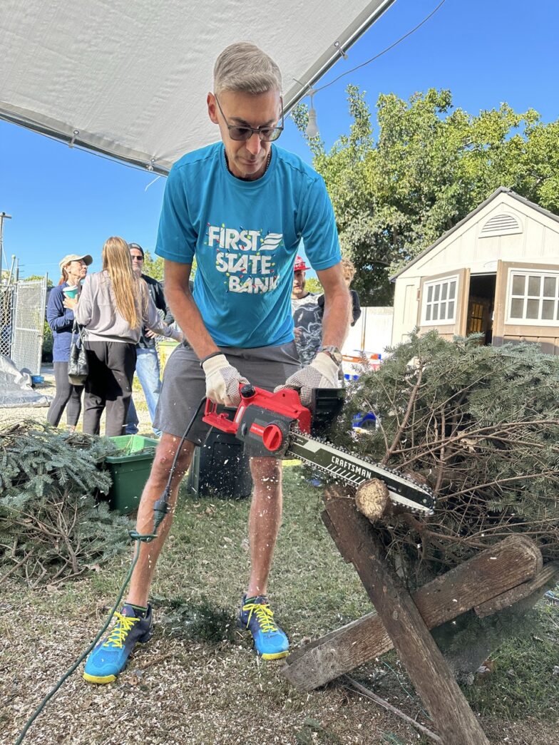 a man using a chainsaw to cut a tree