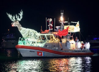 a boat decorated with christmas lights in the water