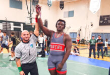 a man standing on a basketball court holding a basketball