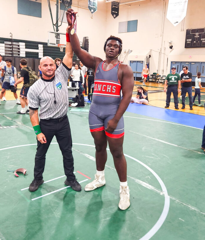 Allens A KW a man standing on a basketball court holding a basketball