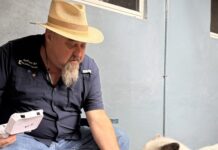 REEF’S REPORT: EVERY DOLLAR COUNTS a man sitting on a bench petting a small white dog