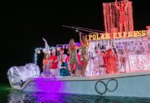 A REIMAGINED HAWK’S CAY MARINA BRINGS THREE DAYS OF FESTIVITIES a group of people standing on top of a boat