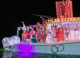 a group of people standing on top of a boat