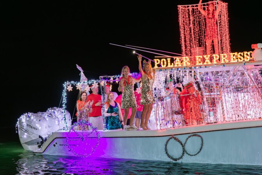 a group of people standing on top of a boat