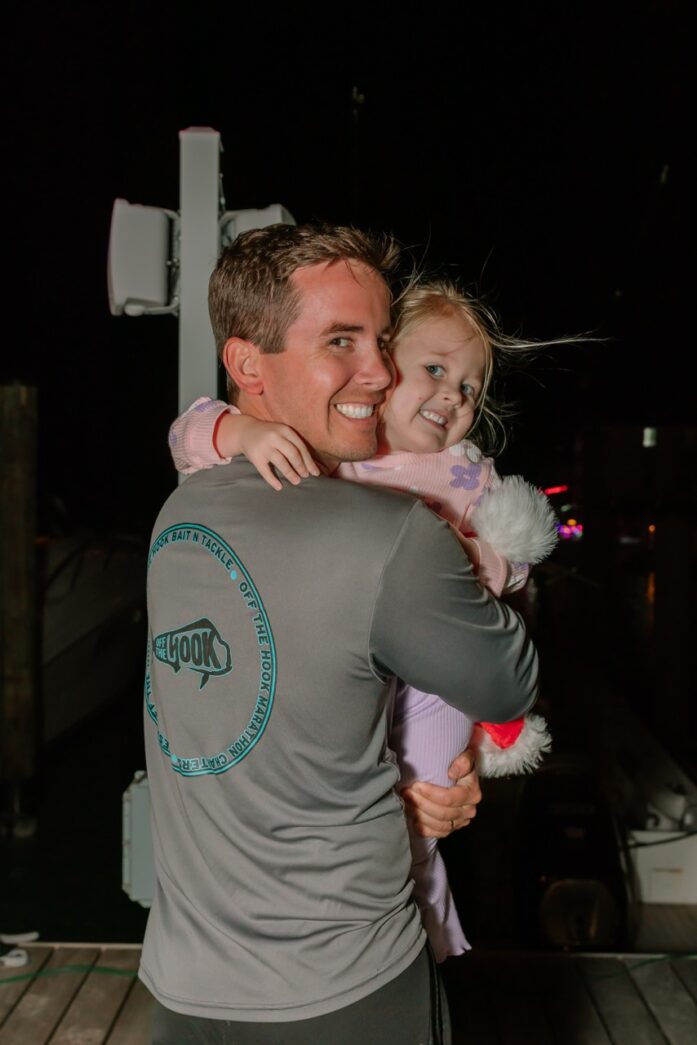 a man holding a little girl in his arms