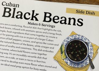 a recipe book on a wooden table with a picture of a bowl of black beans