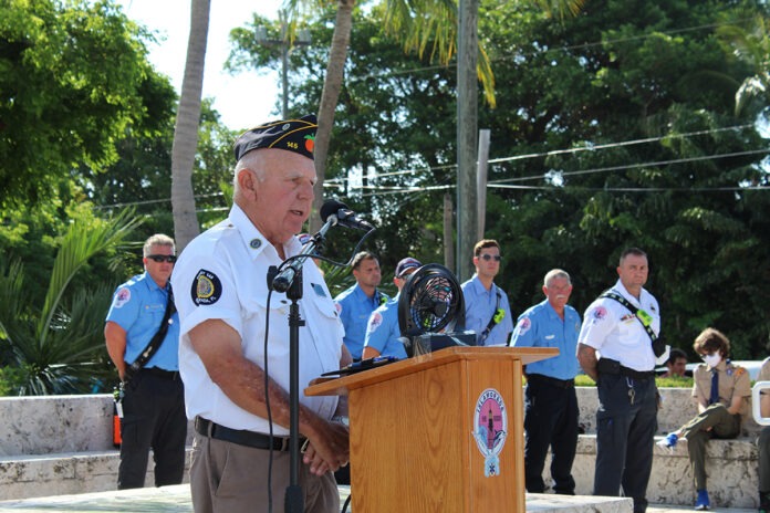 a man standing at a podium in front of a group of people