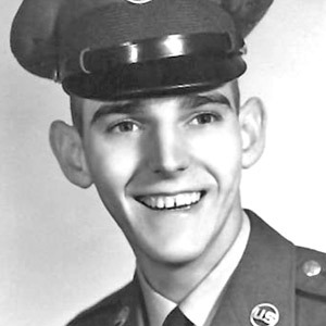 a black and white photo of a man in uniform