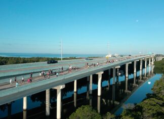 a bridge over a river with people walking on it